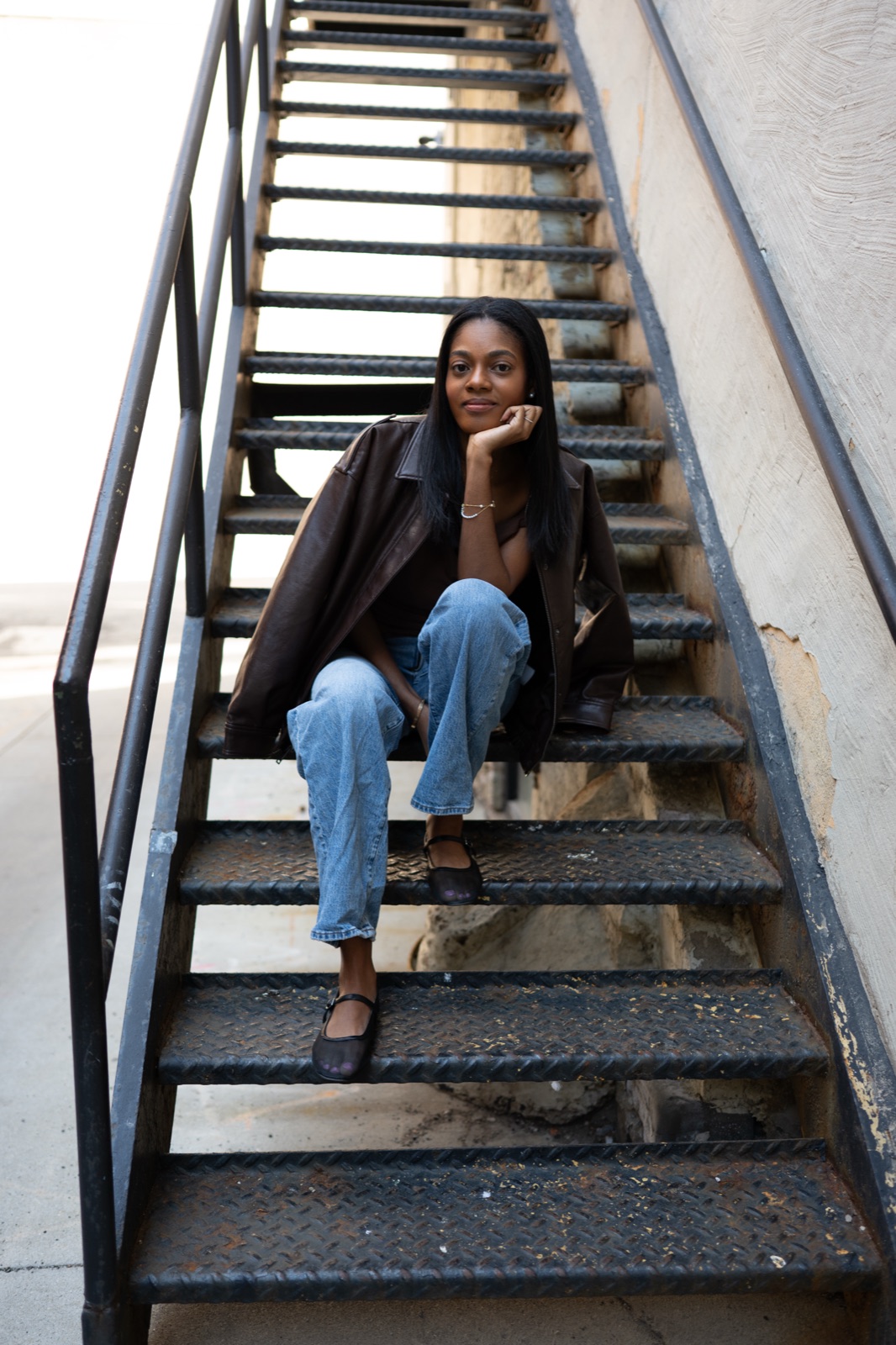 Portrait of Rukiya Ross seated on a staircase